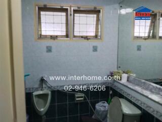 Bathroom with window, sink, mirror, and toilet