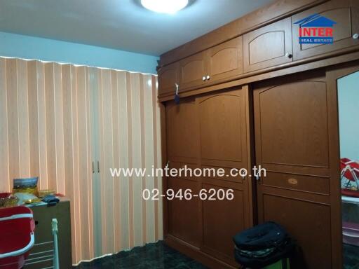Bedroom with wooden built-in wardrobe and vertical blinds