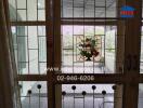 Closed doors leading to a balcony with stained glass panel