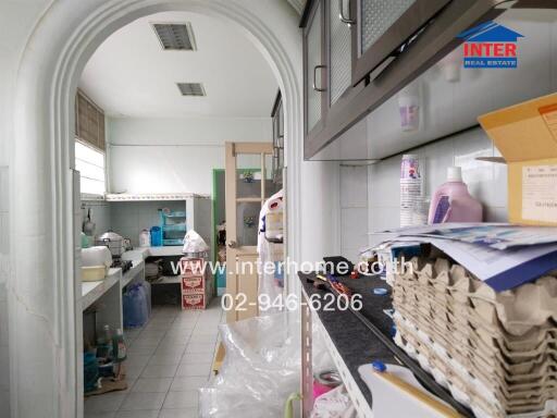 A photo of the kitchen area with various items and appliances.