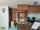 Living area with wooden cabinetry, clock, and various items