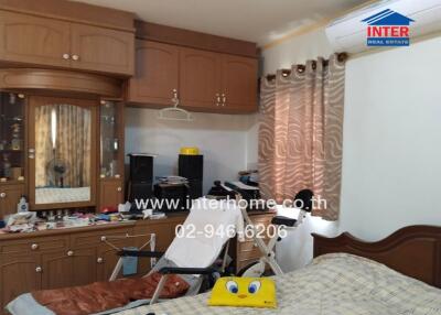 Bedroom with built-in wooden cabinets and air conditioning