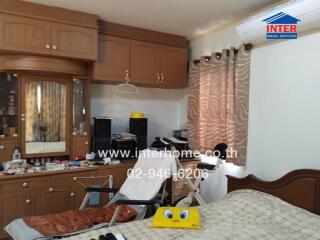 Bedroom with built-in wooden cabinets and air conditioning