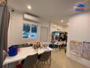 Dining area with table, chairs, and wall-mounted air conditioner