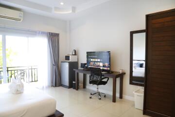 Modern bedroom with desk and entertainment setup