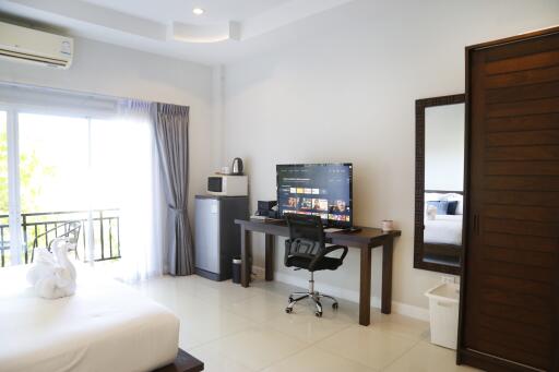 Modern bedroom with desk and entertainment setup