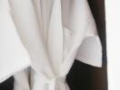 White bathrobe hanging in a closet