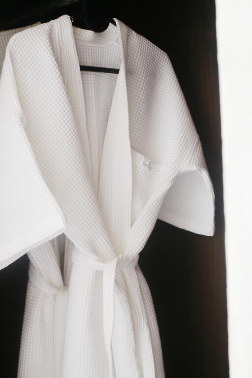 White bathrobe hanging in a closet