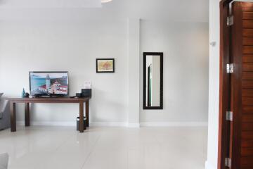 Modern living room with television and wall art
