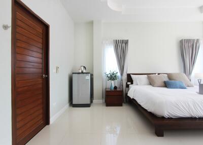Modern bedroom with wooden door and bed