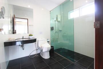 Modern bathroom with glass shower and black and white color scheme