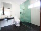 Modern bathroom with glass shower and black and white color scheme