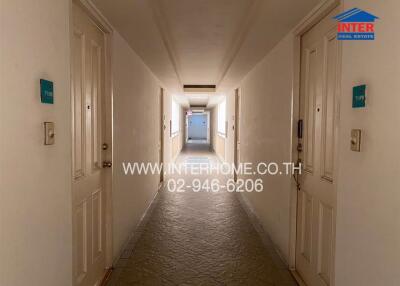 Hallway with doors on either side leading to different units