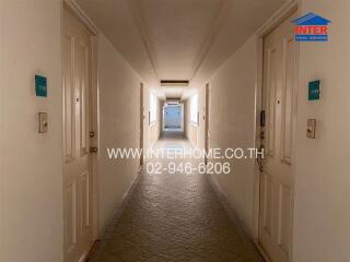 Hallway with doors on either side leading to different units