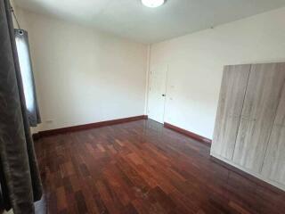 Empty bedroom with wooden floor and wardrobe