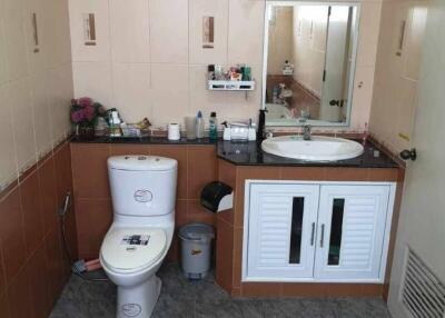 Bathroom with double sinks and a toilet