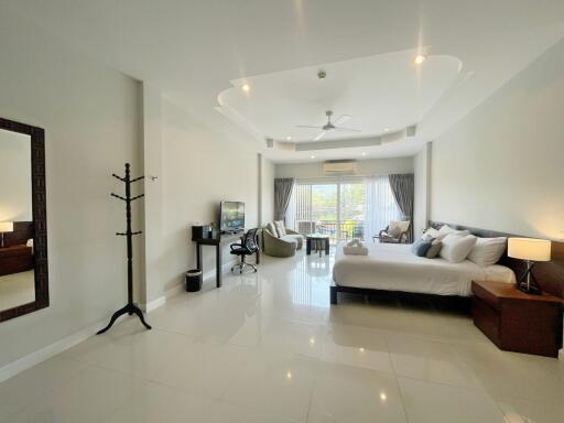 Spacious master bedroom with modern furnishings and natural light