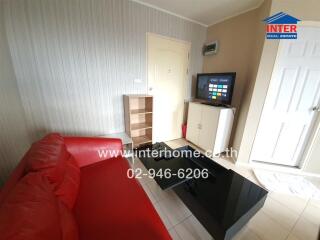 Modern living room with red sofa, TV, and storage furniture