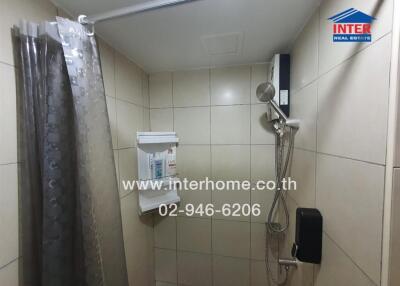 Bathroom with shower, tiles, and toiletries