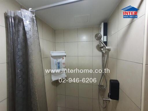 Bathroom with shower, tiles, and toiletries