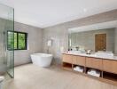 Modern bathroom with freestanding bathtub and large mirror