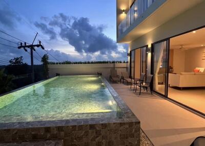 Modern house with swimming pool at sunset