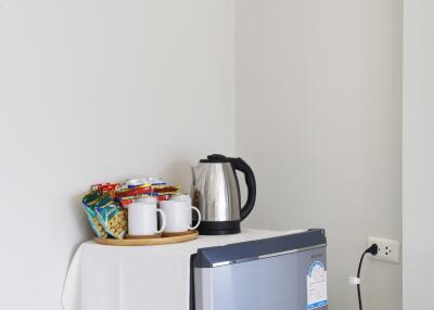 Mini fridge with snacks and a kettle