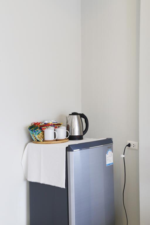 Mini fridge with snacks and a kettle