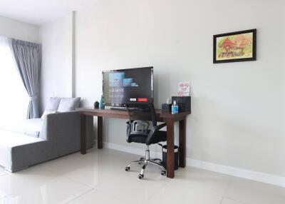 Living room with desk, sofa, and wall painting