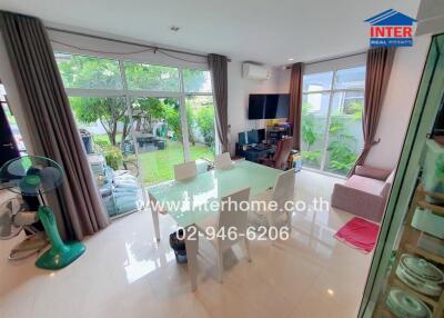 Modern living room with large windows and garden view