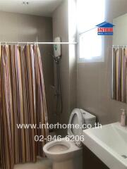 Modern bathroom with shower and striped curtain