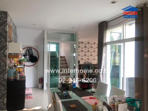 Modern kitchen and dining area with a view of the staircase