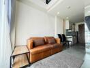 Spacious living area with a brown leather sofa and modern furnishings