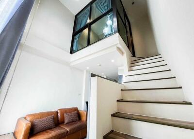 Modern living area with staircase and loft view