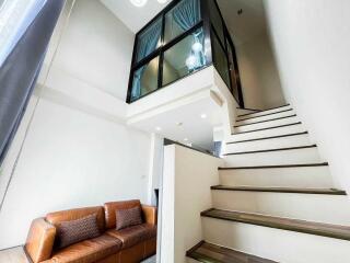 Modern living area with staircase and loft view