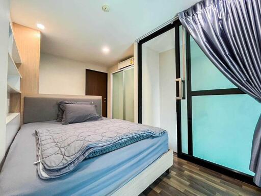 Modern bedroom with gray bedding and sliding glass doors