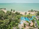 Aerial view of a beachfront property with swimming pool and palm trees