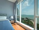 Bedroom with large windows and ocean view