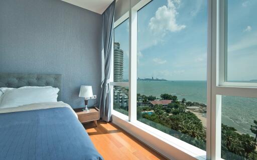 Bedroom with large windows and ocean view