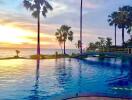 Sunset view of a pool with palm trees