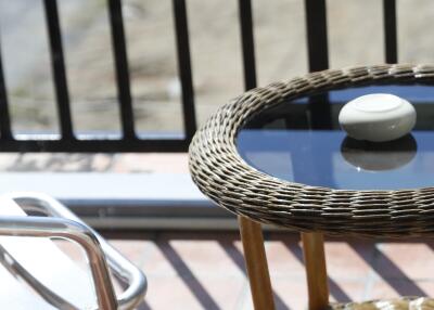 Wicker table and metal chair on balcony