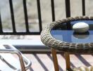 Wicker table and metal chair on balcony