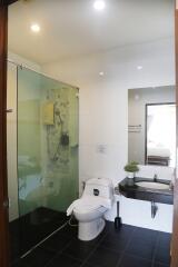 Modern bathroom with glass-enclosed shower and amenities