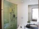 Modern bathroom with glass-enclosed shower and amenities