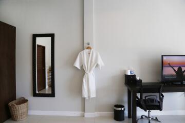 Modern bedroom with work desk and wall-mounted mirror