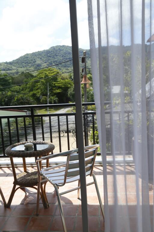 Balcony with a view of mountains and greenery