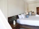 well-lit modern bedroom with white bedding and wooden accents