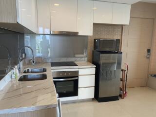 Modern kitchen with marble countertops and stainless steel appliances