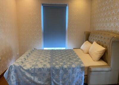 Cozy bedroom with double bed and window with a blind