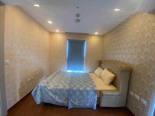 Well-lit bedroom with double bed